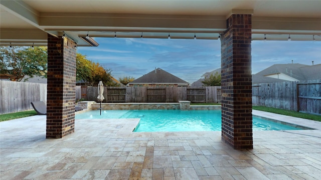 view of pool featuring pool water feature and a patio