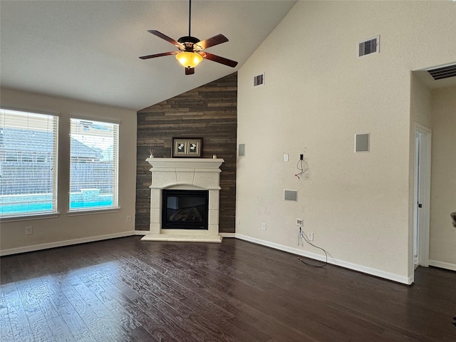 unfurnished living room with ceiling fan, a large fireplace, dark hardwood / wood-style flooring, and high vaulted ceiling