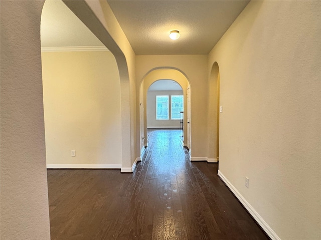 hall featuring dark hardwood / wood-style flooring and a textured ceiling