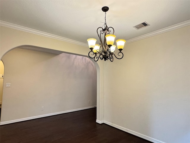 unfurnished dining area featuring dark hardwood / wood-style floors, a chandelier, and ornamental molding