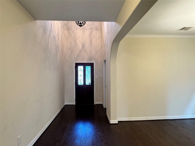 entryway with dark hardwood / wood-style flooring and ornamental molding