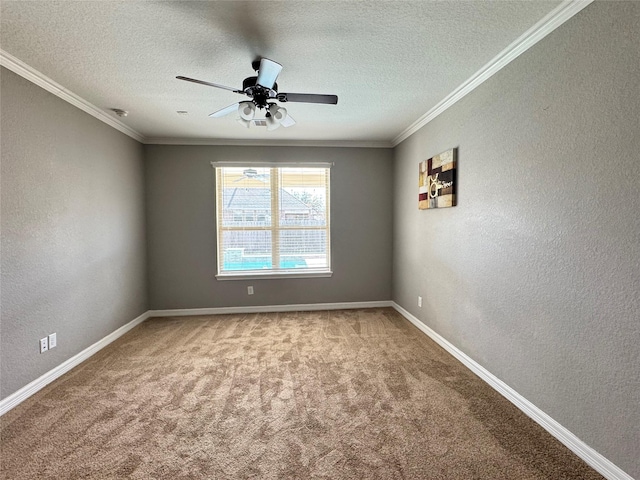 carpeted spare room with ceiling fan, ornamental molding, and a textured ceiling