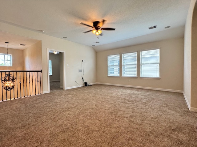 unfurnished room featuring a textured ceiling, carpet flooring, and ceiling fan with notable chandelier