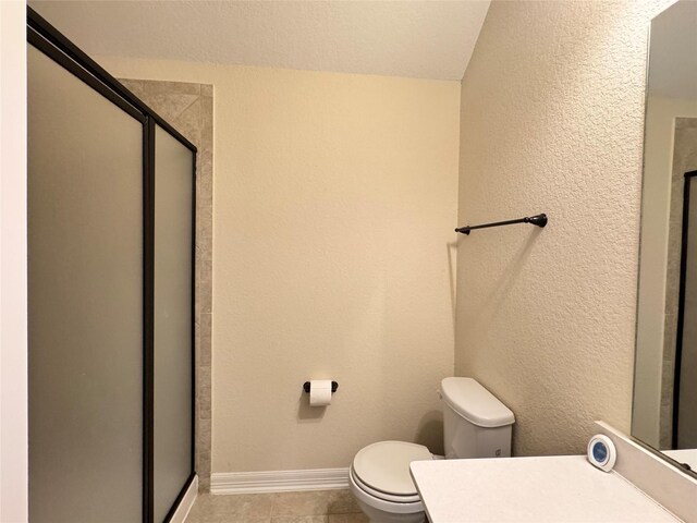 bathroom with toilet and an enclosed shower