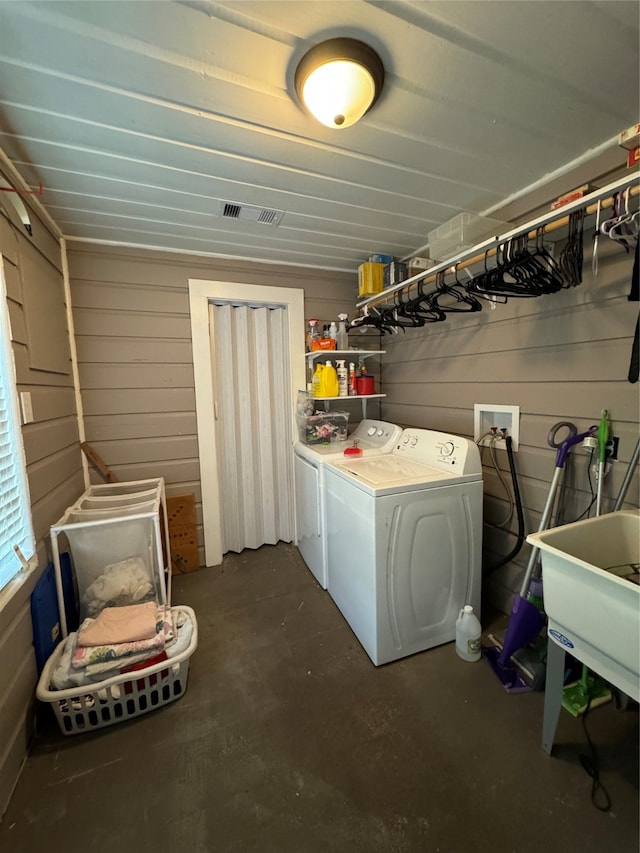 washroom featuring washing machine and clothes dryer and sink