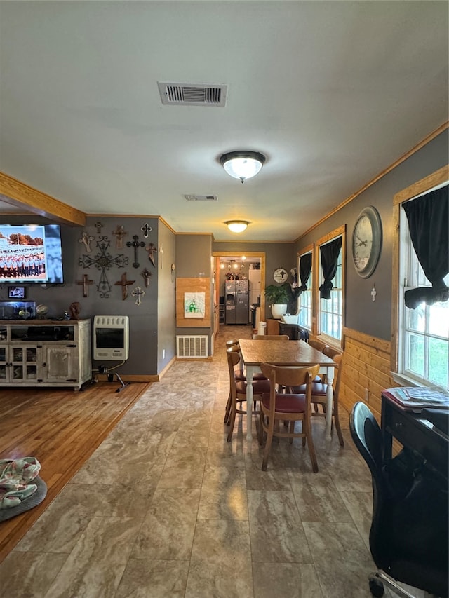 dining space with hardwood / wood-style flooring and ornamental molding