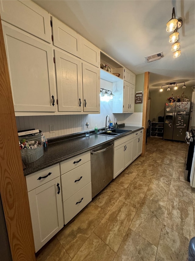 kitchen featuring sink, white cabinets, light tile patterned floors, and stainless steel appliances