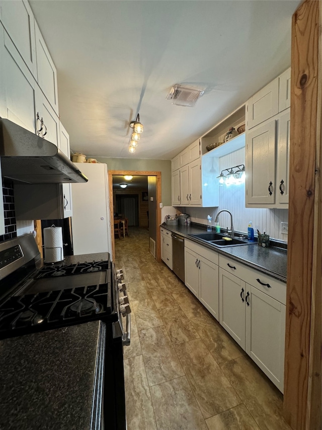 kitchen with white cabinetry, stainless steel appliances, wall chimney exhaust hood, and light tile patterned floors