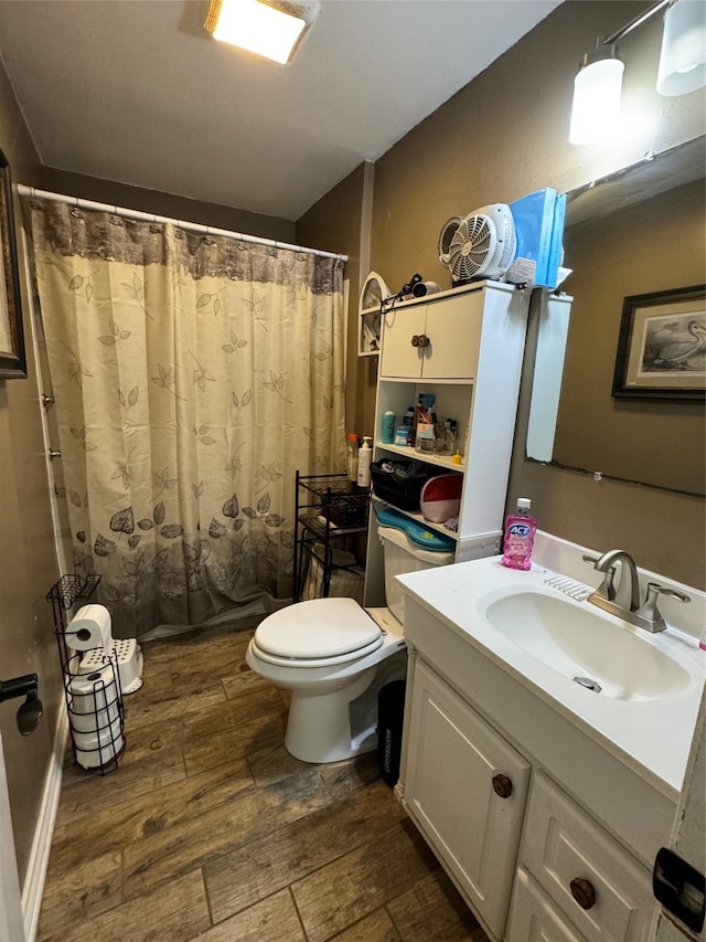 bathroom with vanity, hardwood / wood-style floors, and toilet