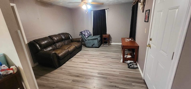 living room with light wood-type flooring and ceiling fan