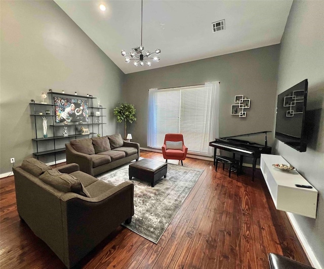 living room featuring an inviting chandelier, high vaulted ceiling, and dark wood-type flooring