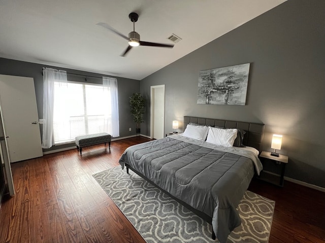 bedroom featuring dark hardwood / wood-style floors, vaulted ceiling, and ceiling fan