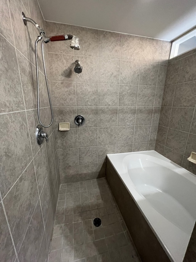 bathroom featuring tiled shower and tile walls