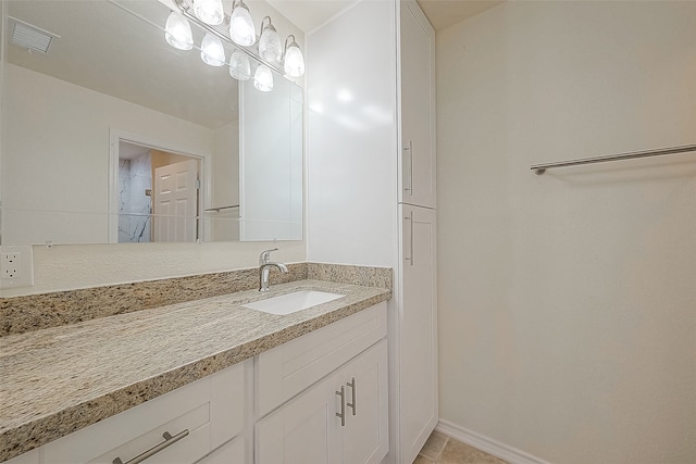 bathroom with vanity and tile patterned floors