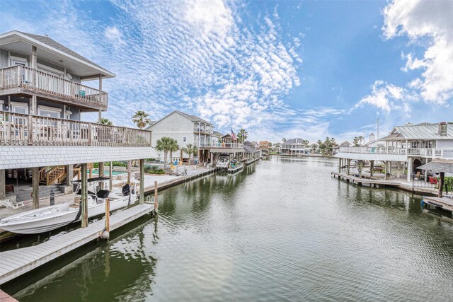 dock area featuring a balcony and a water view