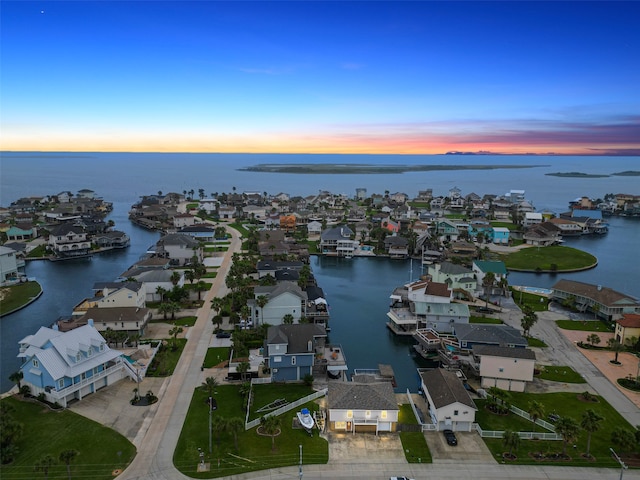 aerial view at dusk with a water view