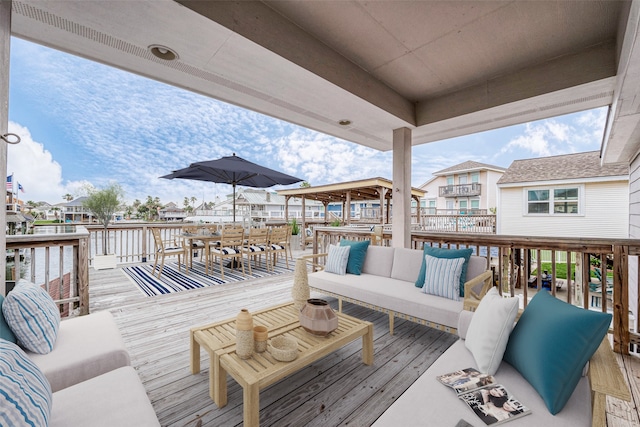 wooden terrace with an outdoor living space