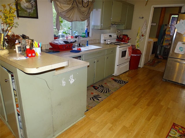 kitchen featuring stainless steel refrigerator, white range with electric cooktop, light wood-type flooring, and green cabinetry