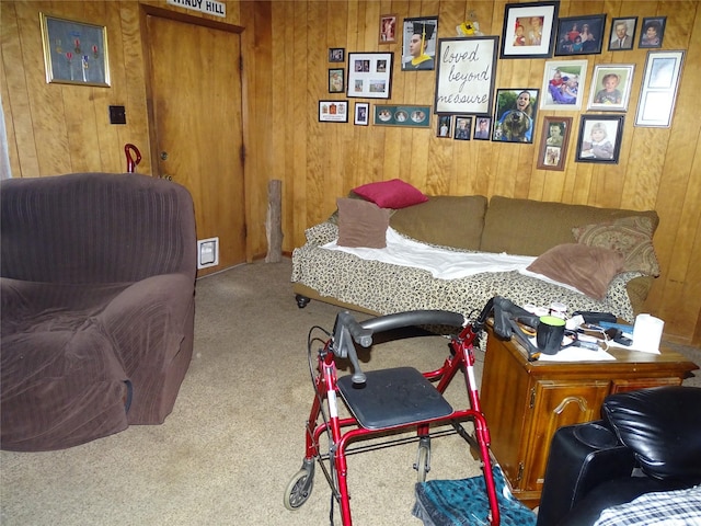 carpeted bedroom with wood walls