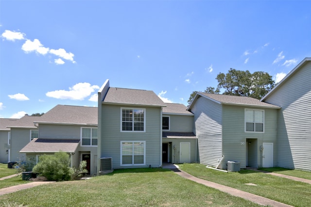 front of property with a front yard and central air condition unit