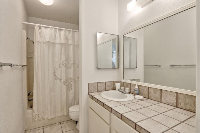 full bathroom with vanity, toilet, shower / bath combination with curtain, and tile patterned flooring