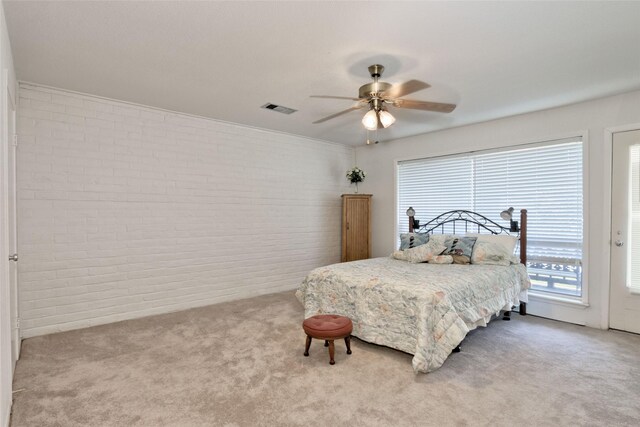 bedroom with light colored carpet, brick wall, and ceiling fan