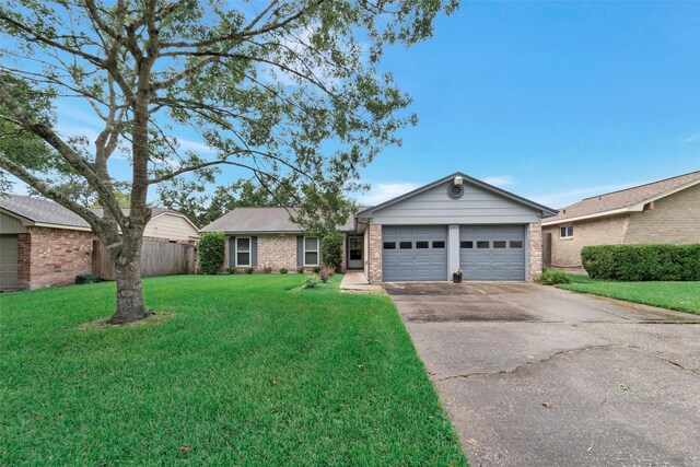 ranch-style house with a garage and a front yard