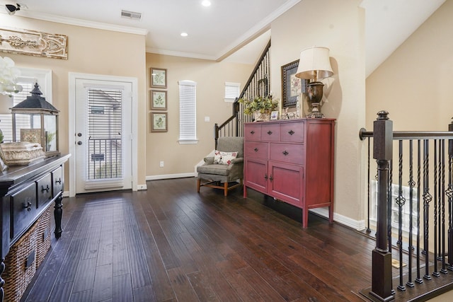 living area featuring dark wood-type flooring and ornamental molding