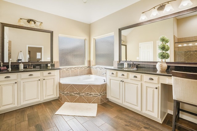 bathroom featuring separate shower and tub and vanity