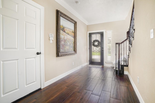 entryway featuring crown molding and a textured ceiling