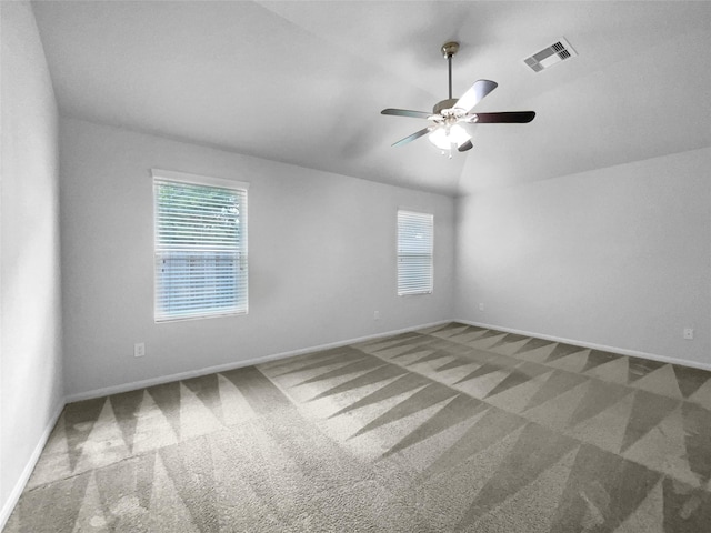 unfurnished room featuring ceiling fan, carpet flooring, and vaulted ceiling