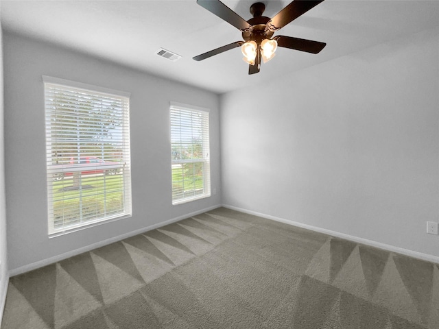 unfurnished room featuring ceiling fan and carpet