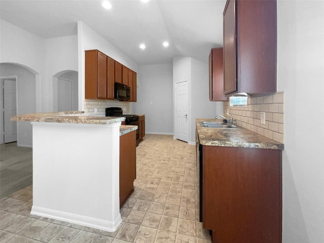 kitchen featuring sink, backsplash, black appliances, and kitchen peninsula