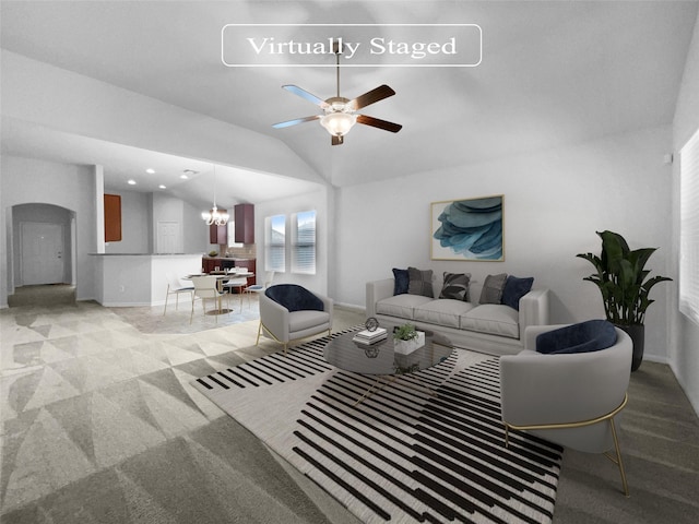 living room with light carpet, ceiling fan with notable chandelier, and vaulted ceiling