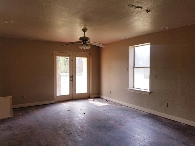 empty room with hardwood / wood-style floors, a textured ceiling, and ceiling fan