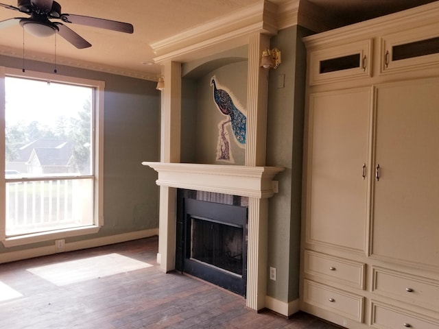 unfurnished living room featuring crown molding, hardwood / wood-style flooring, and ceiling fan