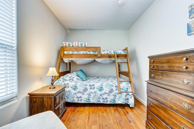 bedroom featuring baseboards and wood finished floors