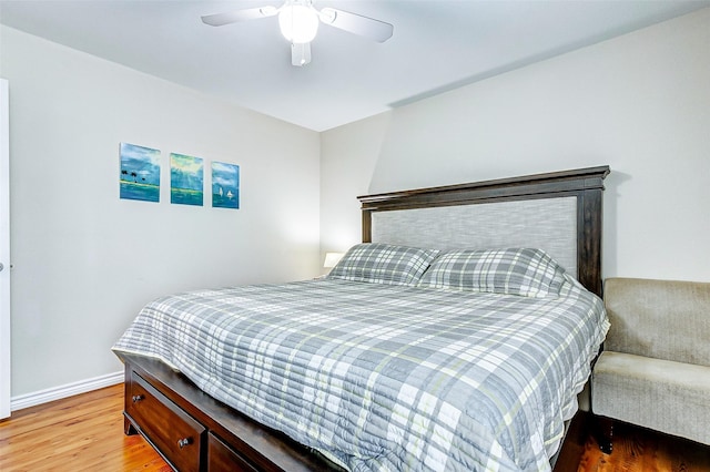 bedroom featuring ceiling fan, baseboards, and wood finished floors