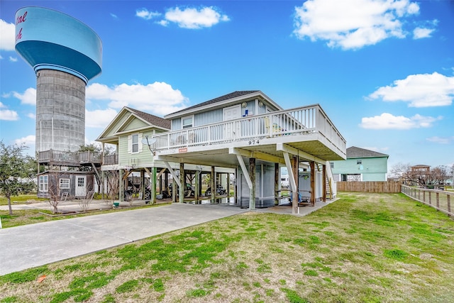 view of front of property with driveway, stairs, fence, a front lawn, and a carport