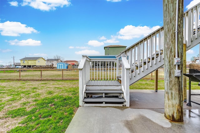 exterior space featuring stairs, a deck, and fence