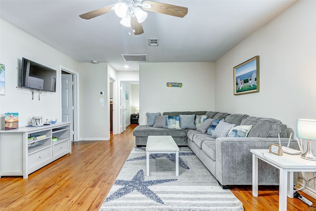 living room with ceiling fan and light wood-type flooring