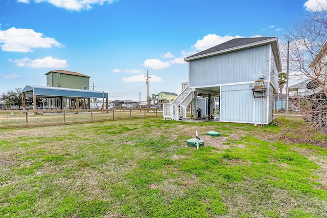 view of yard featuring fence and stairway