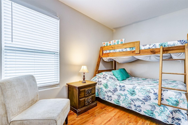 bedroom featuring lofted ceiling and wood finished floors