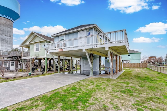 view of front facade featuring stairs, a carport, concrete driveway, and a patio area