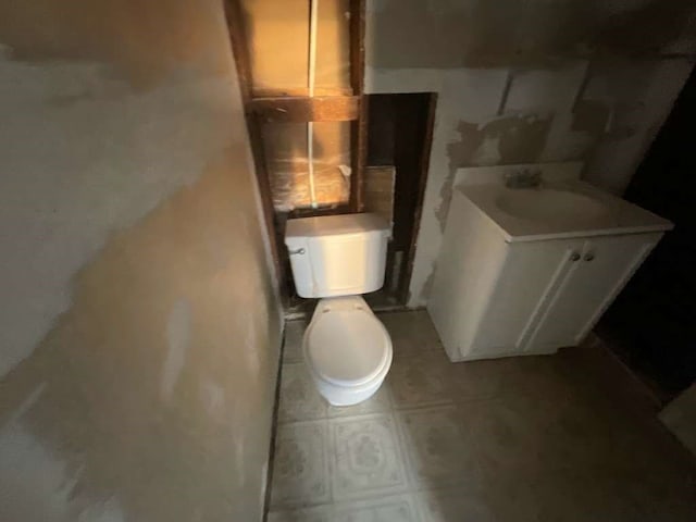 bathroom with vanity, tile patterned flooring, and toilet