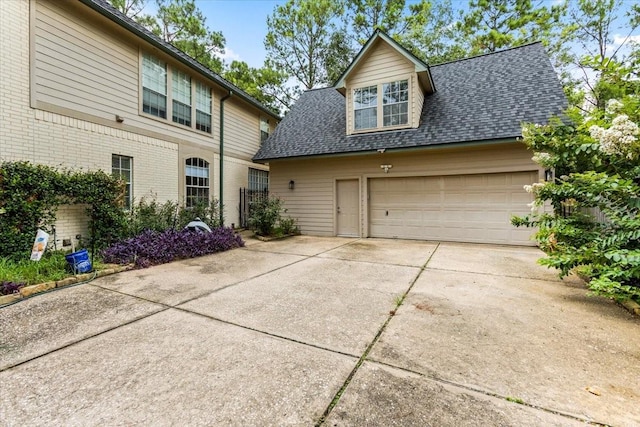 view of front facade with driveway, a shingled roof, an attached garage, and brick siding