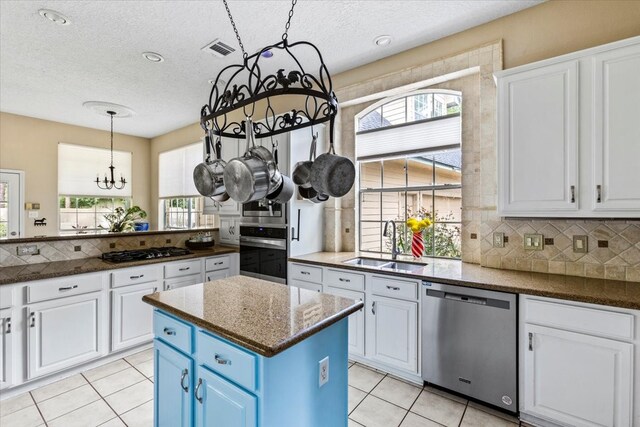 kitchen with plenty of natural light, sink, a center island, and appliances with stainless steel finishes