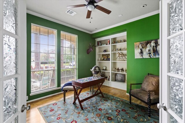 office featuring ceiling fan, a wealth of natural light, and light hardwood / wood-style flooring