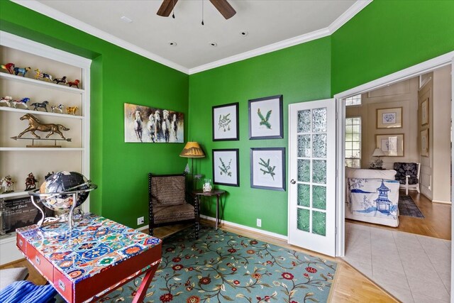 living area with crown molding, ceiling fan, and hardwood / wood-style floors