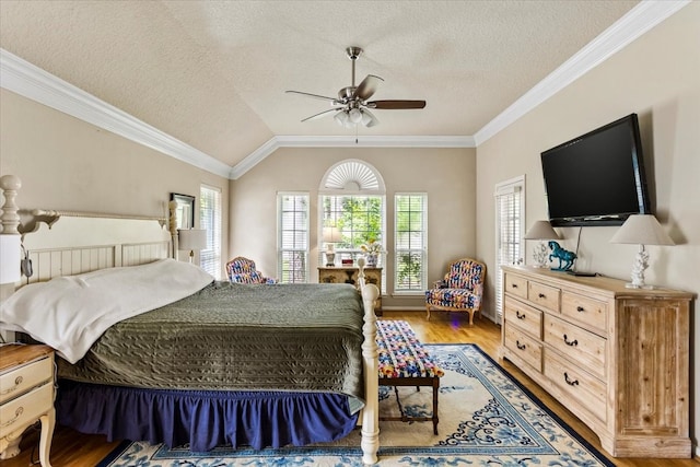 bedroom featuring lofted ceiling, hardwood / wood-style flooring, ceiling fan, and a textured ceiling